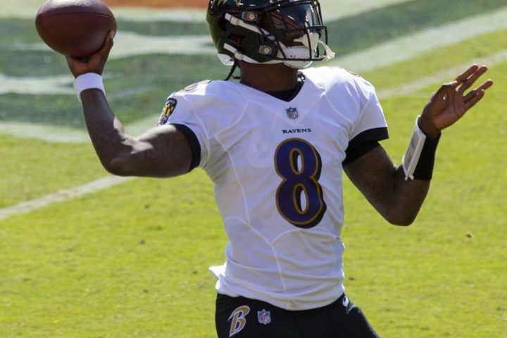 A passer at the top of his follow-through, front foot planted, the ball already gone.
